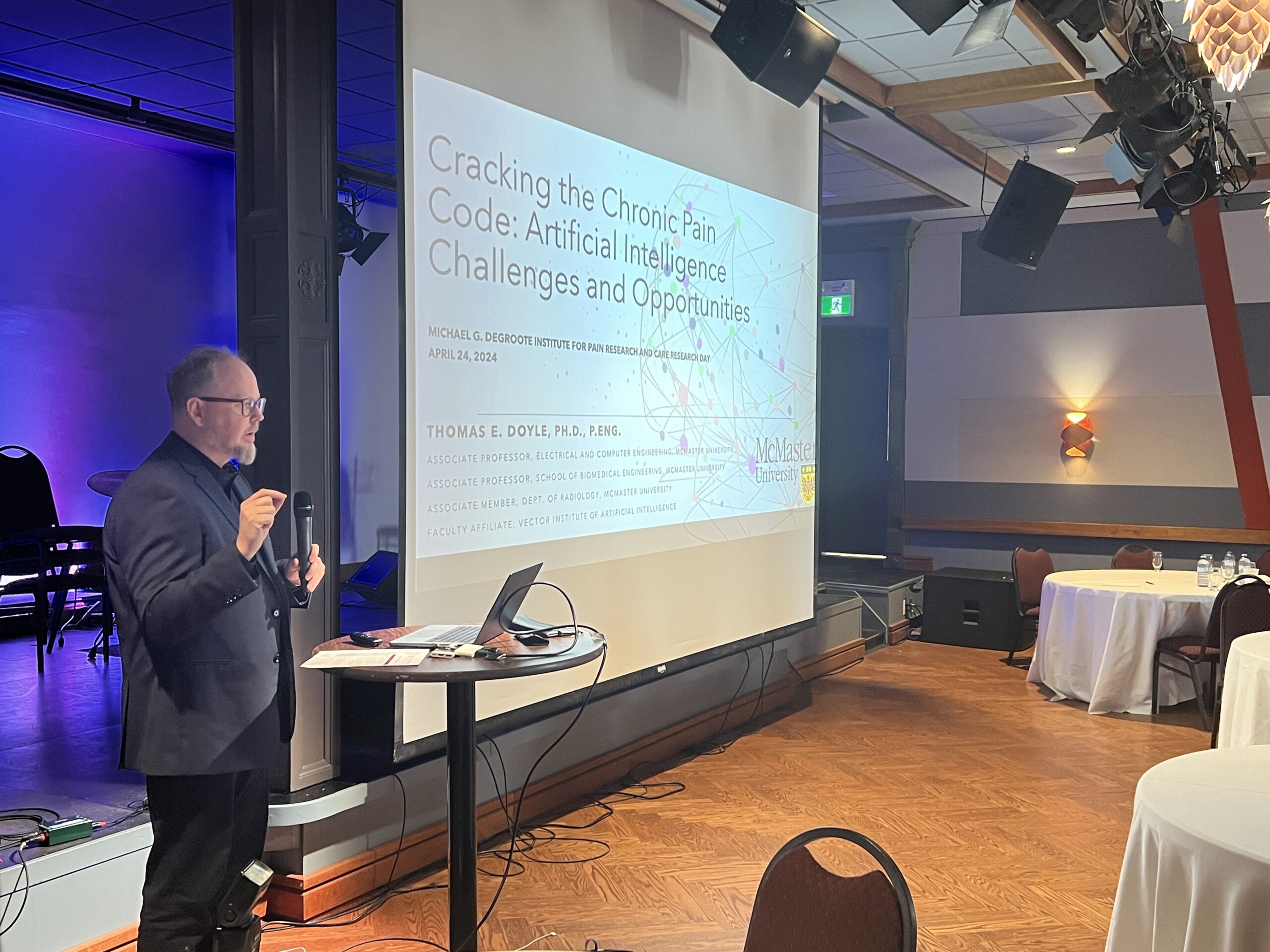 Dr. Thomas Doyle stands behind a podium while speaking at the IPRC's Research Day 2024.